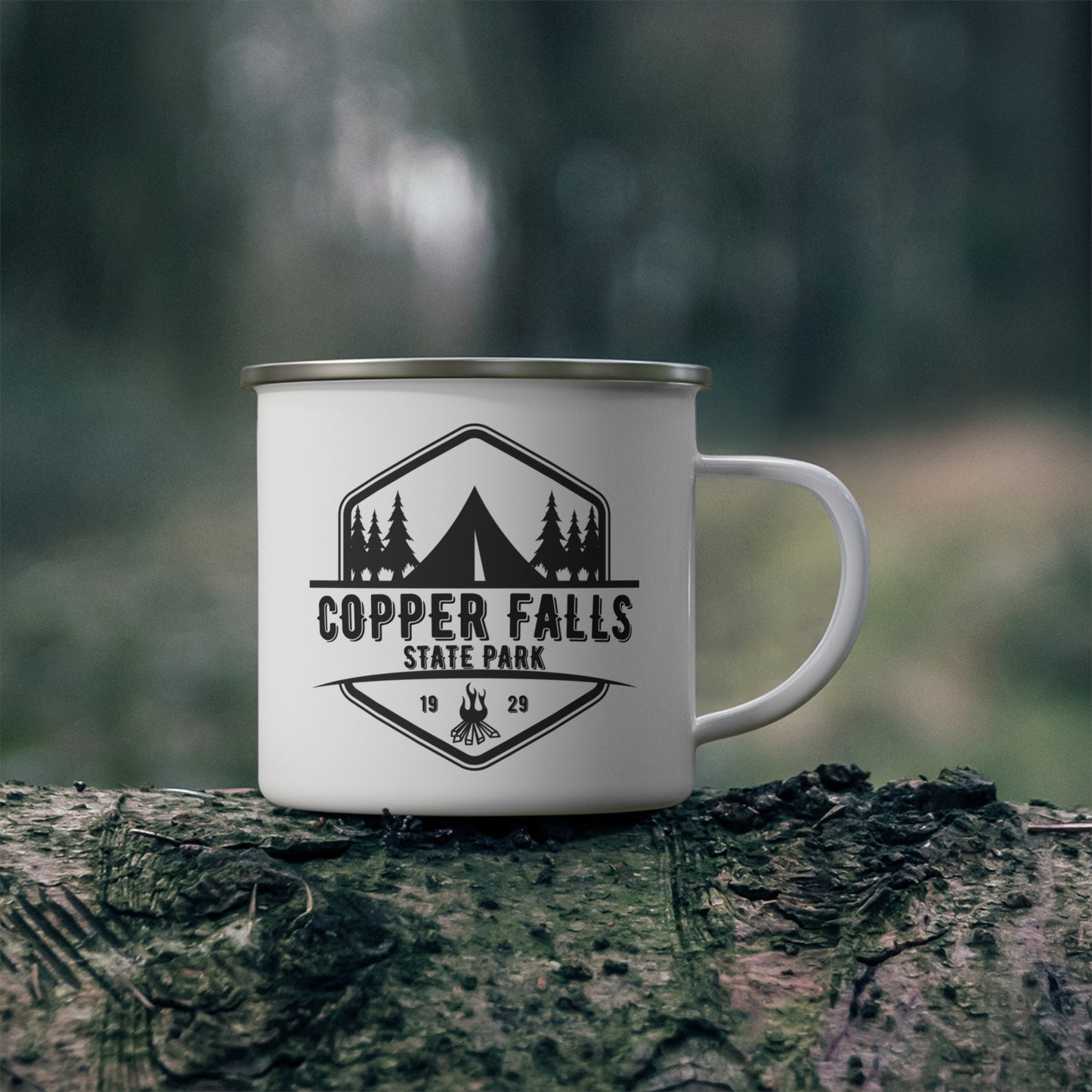 White camper mug depicting a tent and campfire and the wording Copper Falls State Park.