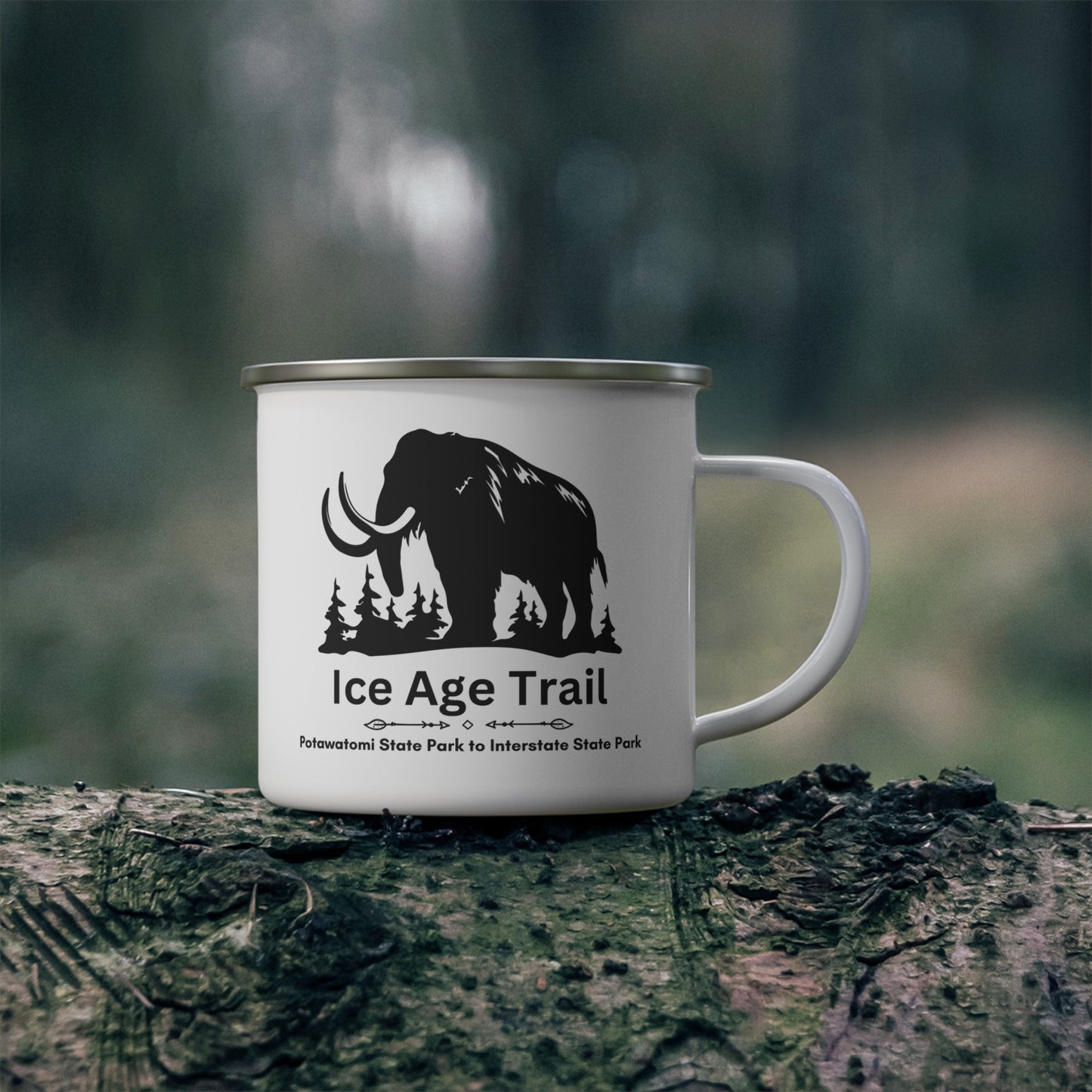 White enamel Ice Age Trail camper mug with silver lip.  Features a depict of a mammoth and the text “Ice Age Trail, Potawatomi State Park to Interstate State Park”.