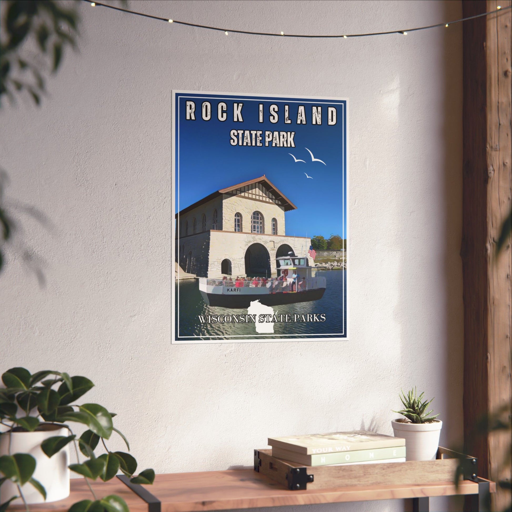 Vintage style poster depicting the Rock Island State Park boathouse and the Karfi passenger ferry.  Photo background: poster hanging on a wall above a shelf with books and plants.