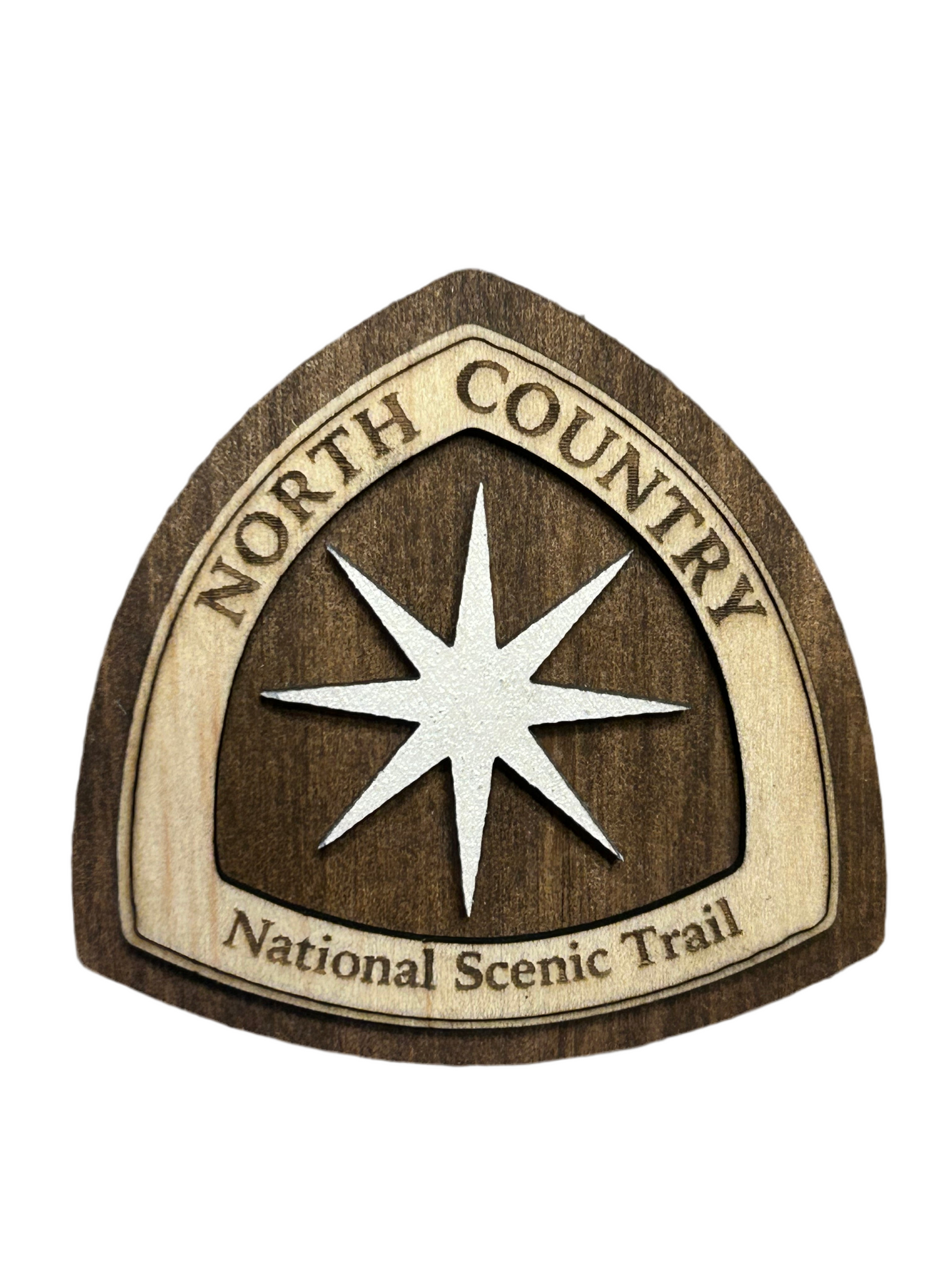 National Trail Icon with Text "North Country National Scenic Trail" and a White Polaris Star Icon on a walnut-colored background. 