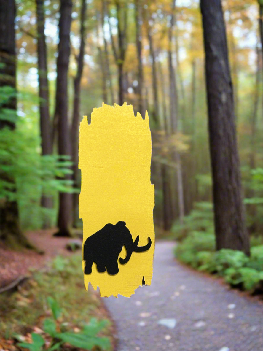 Yellow painted wood National Trail Blaze magnet with a black mammoth icon on the bottom half of the magnet. 