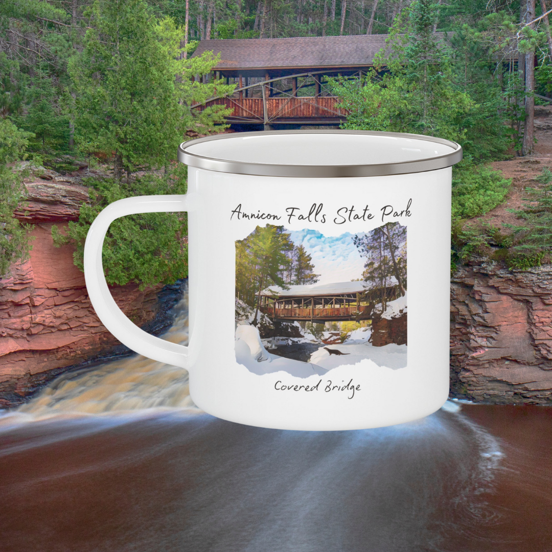 White enamel mug depicting the covered bridge at Amnicon Falls State Park in winter.  Background: Amnicon falls.